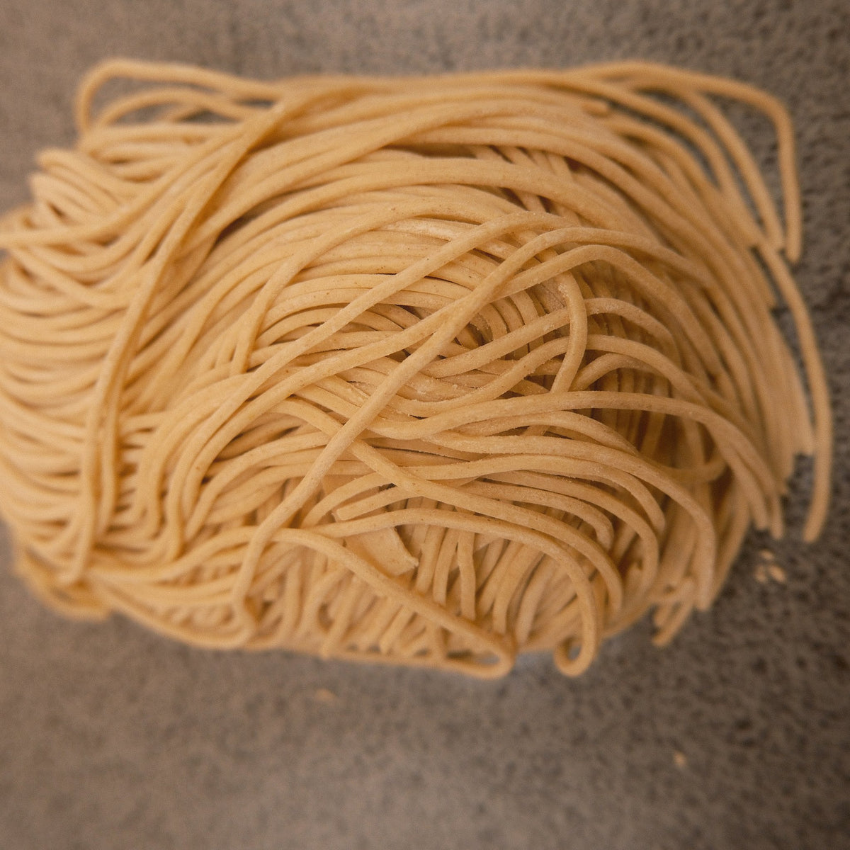 Close up of thin, pale Hakata style noodles