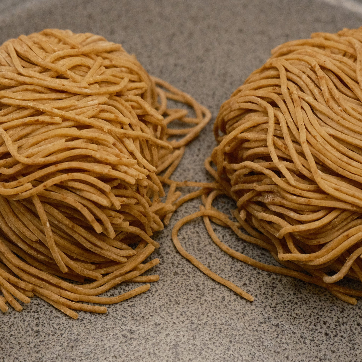 Close up of rye Tokyo style noodles on a stone plate